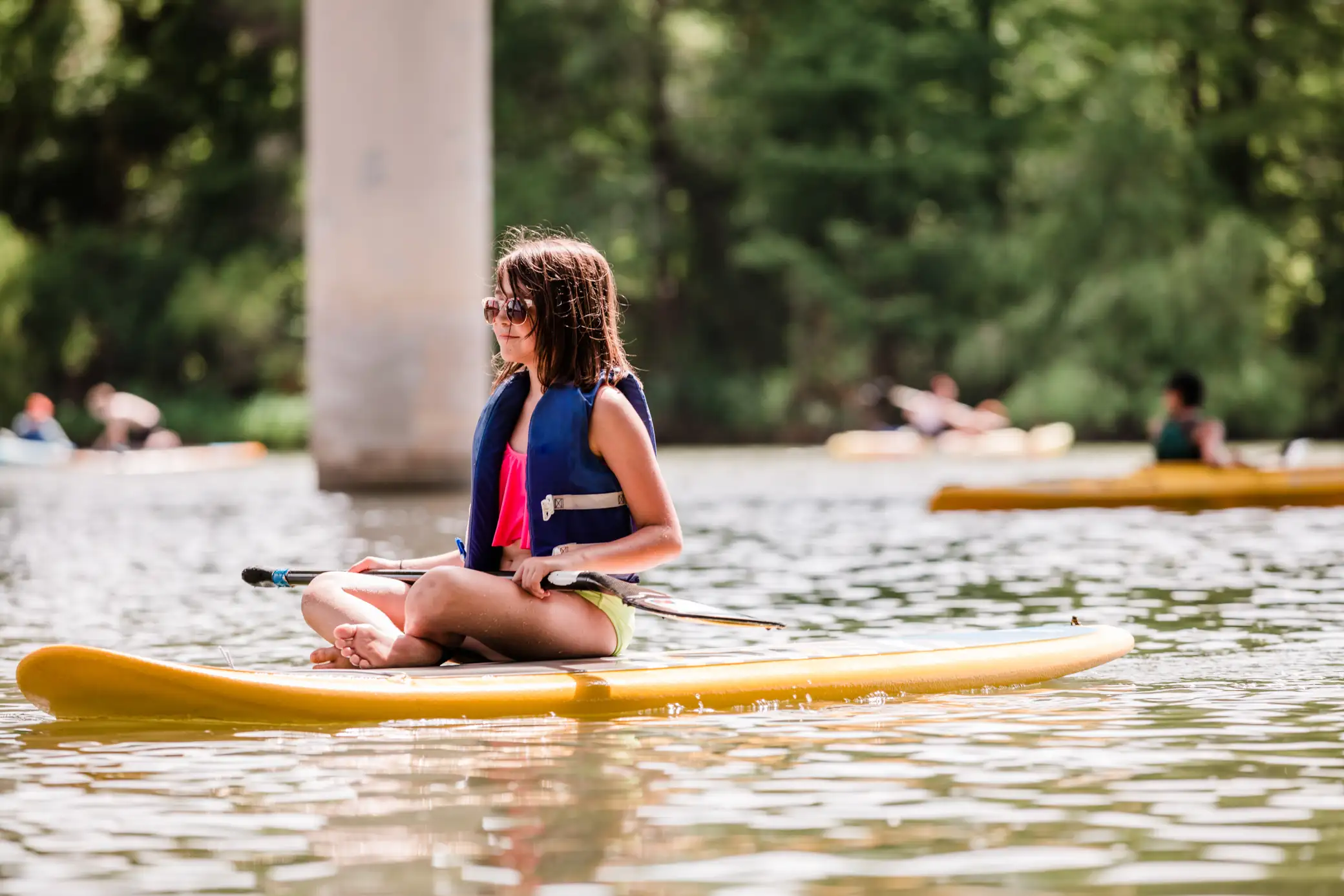 A photo of a young girl on a kayak